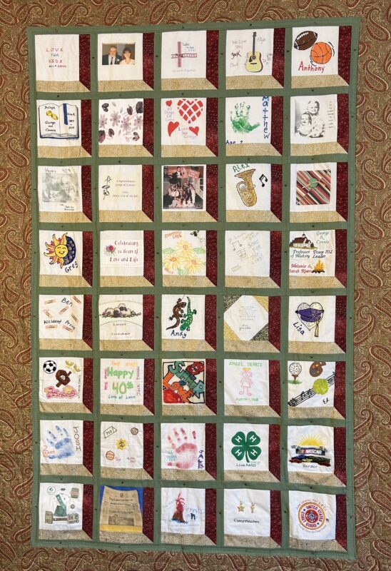 Photo of a quilt with forty squares bearing different drawings and compositions.