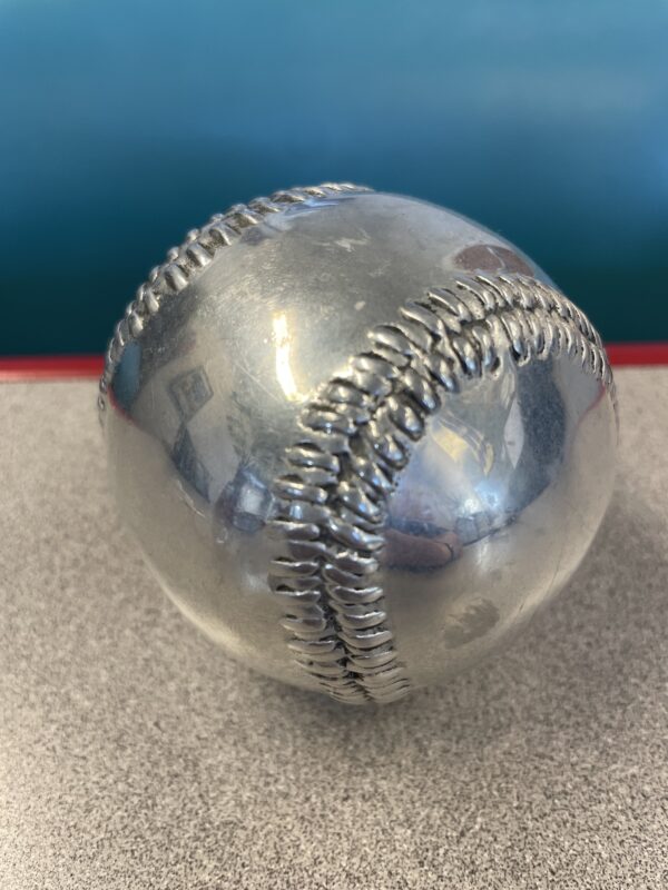 Photo of a silver baseball paperweight.