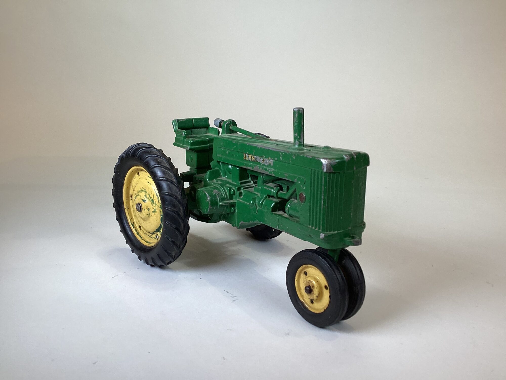 Photo of a small model of a green tractor.