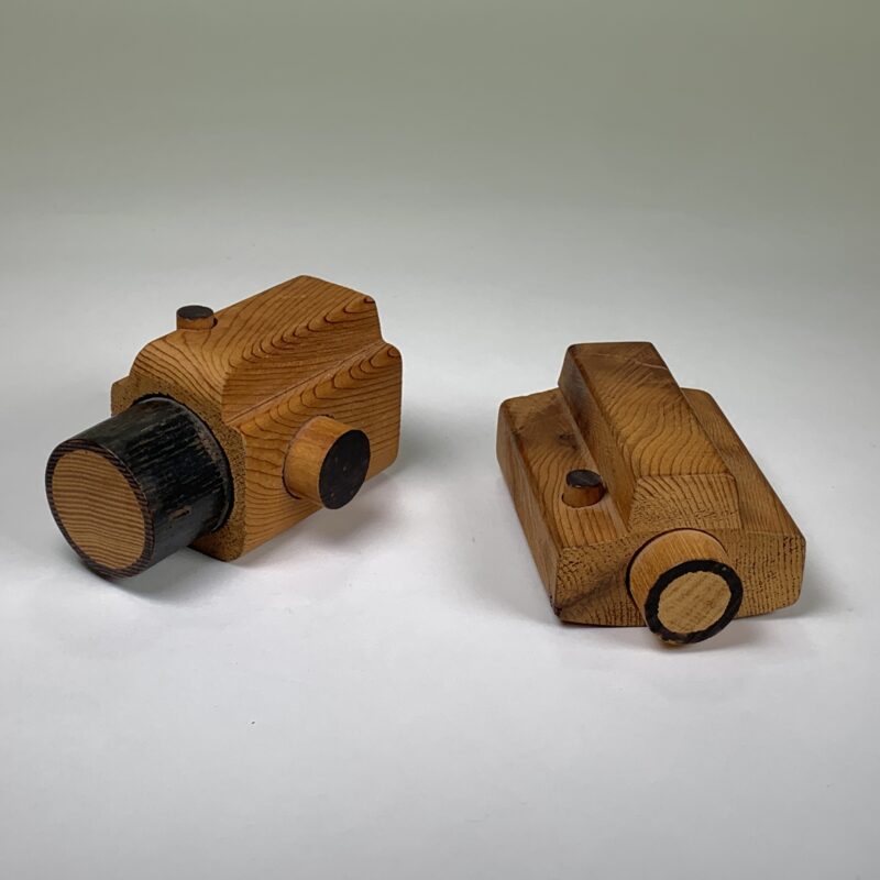 Photo of two small wooden cameras.